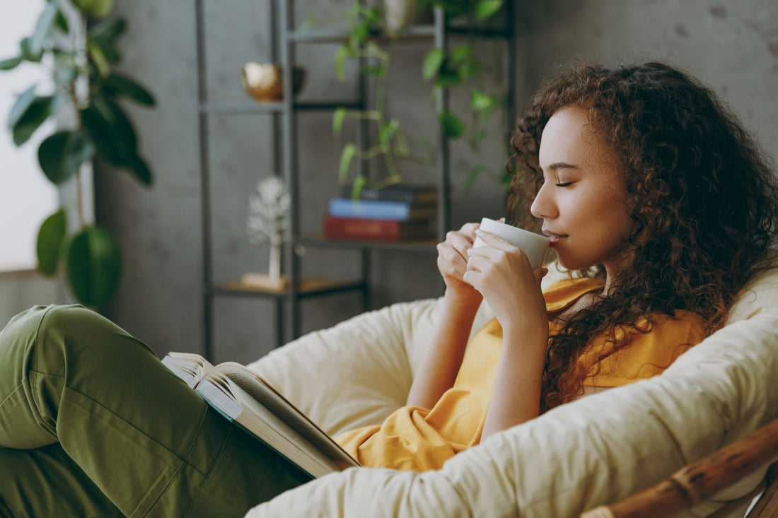 Woman drinking herbal tea while practicing grounding rituals